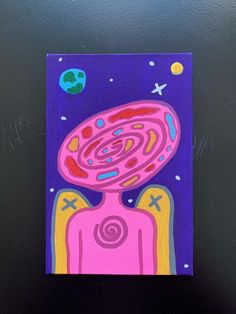 a painting on a black surface with an alien like object in the center and stars around it