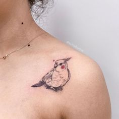 a woman with a bird tattoo on her chest