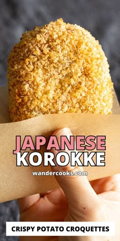 a close up of a person holding a piece of food in front of the words japan korokke