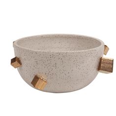 a white bowl with gold handles and two square knobs on the side, in front of a white background