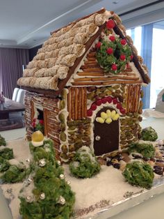 a gingerbread house decorated with icing and decorations