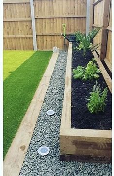 an outdoor garden with gravel and grass