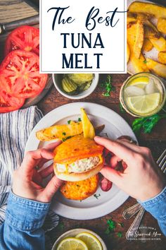 the best tuna melt recipe on a white plate with lemons and tomatoes in the background