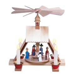 a nativity scene with candles and figurines in front of a white background