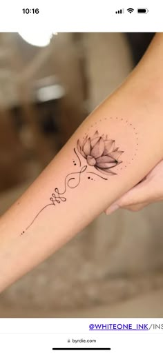 a woman's arm with a tattoo on it that has a flower in the middle