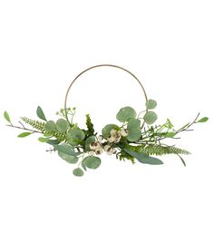 an arrangement of green leaves and flowers in a hoop