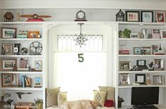 a living room filled with furniture and lots of shelves