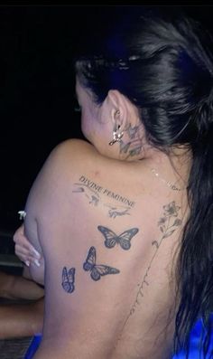 a woman with tattoos on her back