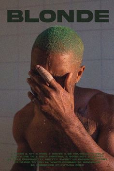 a man with green hair covering his face