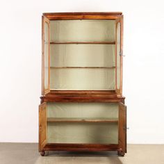 an old wooden display case with glass doors and mesh coverings on the front side