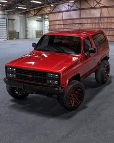 a red pick up truck parked in a garage