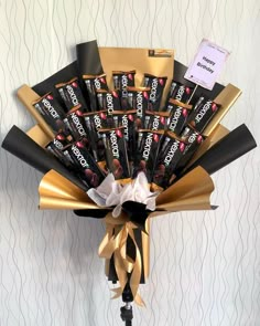 a bouquet of chocolate bars wrapped in gold ribbon