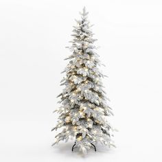 a white christmas tree with lights and snow on the branches is shown in front of a white background