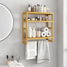 a wooden shelf with towels, soaps and other items on it next to a mirror