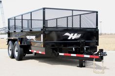 a large black trailer parked in a parking lot