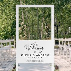 an outdoor wedding ceremony with white chairs and a sign that says the wedding on it