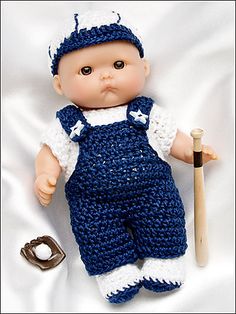 a baby doll is posed with a baseball bat