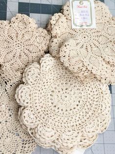 crocheted doily sitting on top of a table next to a package of scissors