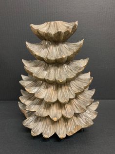 this is an image of a decorative christmas tree made out of seashells on a black background