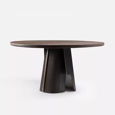 a round wooden table with black metal legs and a circular wood top, on a white background