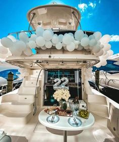 a table with balloons on it in the middle of a boat