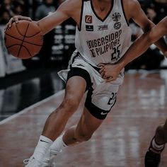 a basketball player dribbles the ball during a game in black and white colors