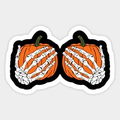 two stickers with skeleton hands holding a pumpkin in the shape of a skeleton hand