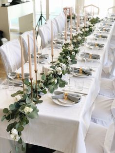 a long table is set with candles and plates