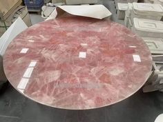 a large round table with pink marble on it