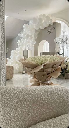 a large bouquet of flowers sitting on top of a white table next to a mirror