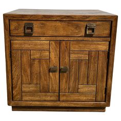 a wooden cabinet with two doors and drawers