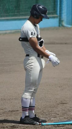 a baseball player is standing on the field