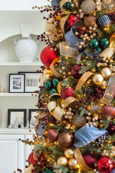 a christmas tree decorated with gold, red and green ornaments