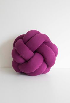 a purple knot sitting on top of a white table