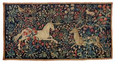 an old tapestry with two unicorns and flowers on the side, one is white