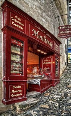 the outside of a storefront with signs above it that read moulieree