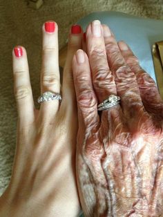 two hands holding each other with rings on their fingers