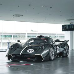 a black and silver sports car parked in front of a building