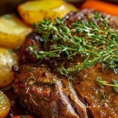 a close up of some meat and vegetables on a plate with potatoes, carrots and broccoli