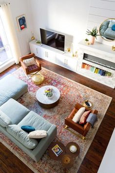 an overhead view of a living room with couches, chairs and a rug on the floor