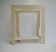 a wooden frame sitting on top of a white table