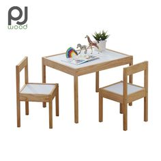 a small wooden table with two chairs and a toy giraffe on the table