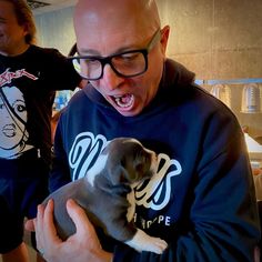 a man holding a small dog in his hands