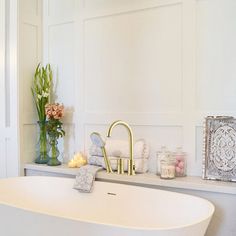 a white bath tub sitting next to a window