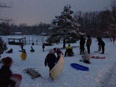 a group of people standing around in the snow