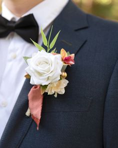 a man in a tuxedo wearing a boutonniere