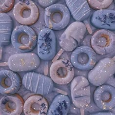 many donuts with frosting and sprinkles are arranged in a pattern