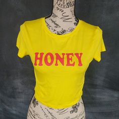 Honey Crop Top Tee. Not Cotton, Made Of Slinky Fabric. Brand New, Never Worn. Bundle 2 Items In My Store For 4.99 Shipping.Bundle 8 Items From My Closet And Get Free Shipping + $1 Off Each Item Over $6. Trendy Yellow Stretch T-shirt, Trendy Stretch Yellow T-shirt, Trendy Yellow Top With Text Print, Cute Yellow Stretch Tops, Cute Stretch Yellow Tops, Spring Yellow Graphic Print Crop Top, Trendy Yellow Crew Neck Crop Top, Trendy Yellow Crop Top With Graphic Print, Crop Top Tees