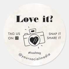 a round sticker with the words love it? and an image of a camera