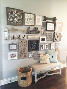 a wall filled with lots of different types of framed pictures and letters on it's side